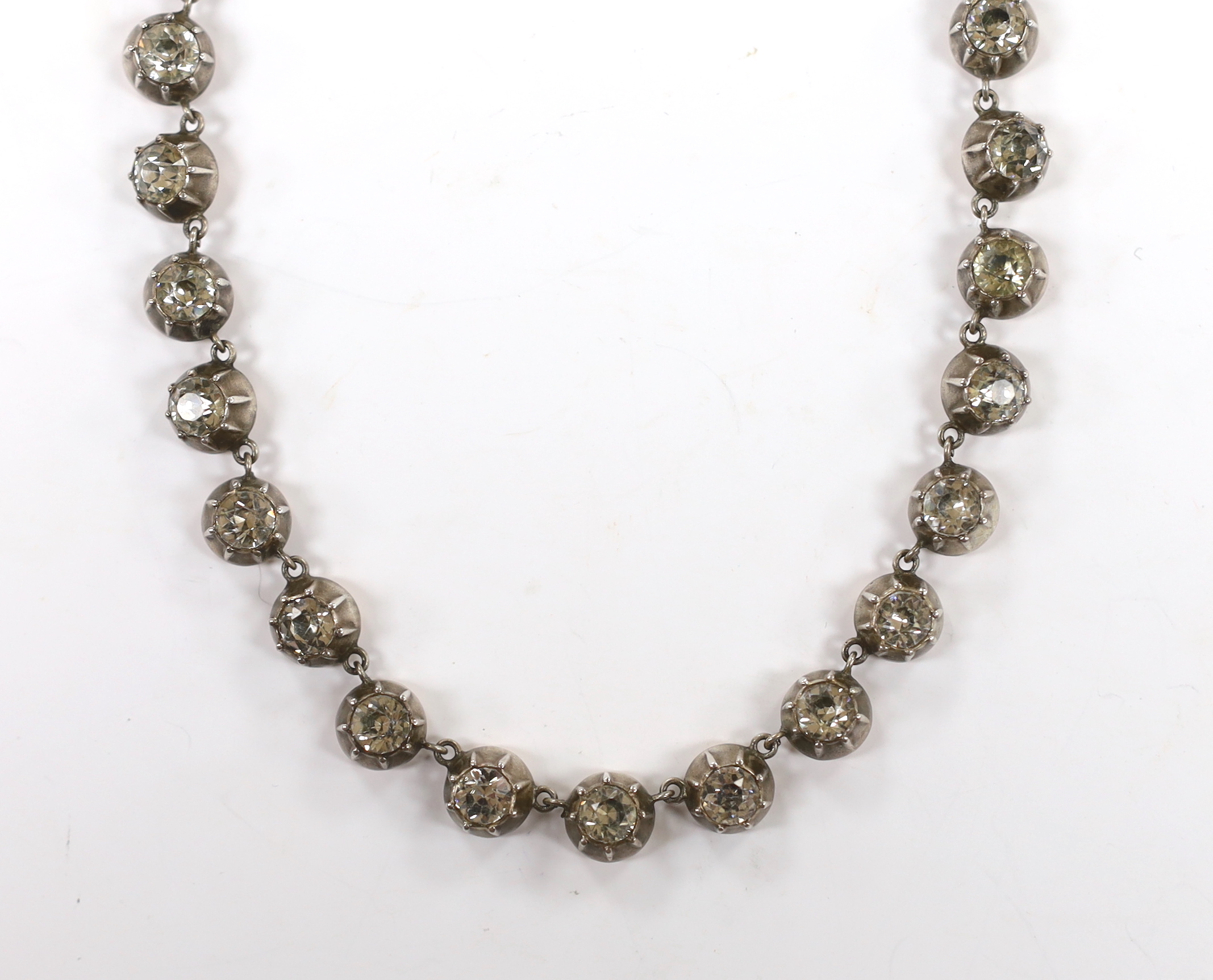 An early 19th century yellow and white metal, foil backed paste set necklace, with later 585 clasp, 32cm.